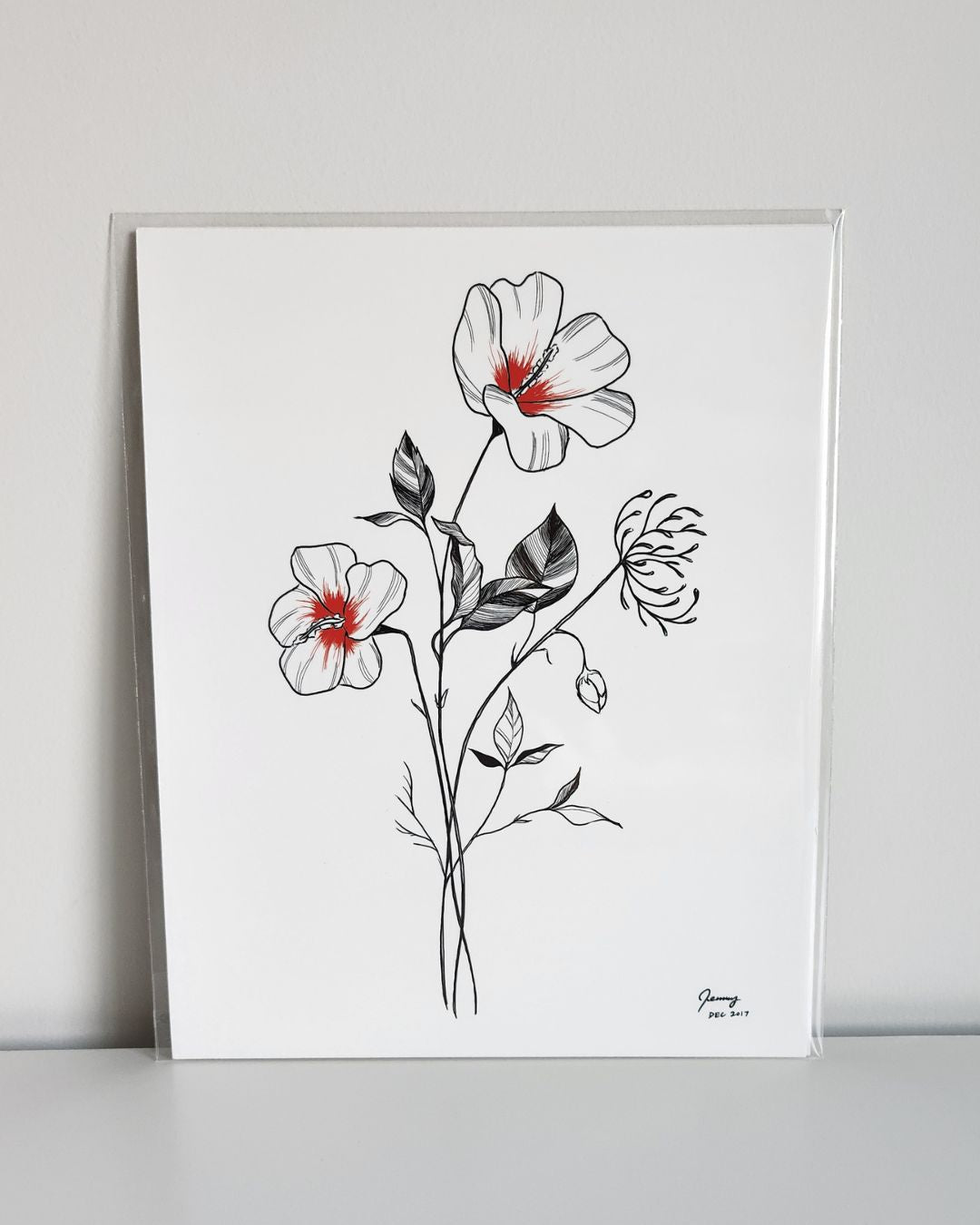 Korean hibiscus line drawing art print by Full Art Alchemist, sleeved and standing upright against a white wall