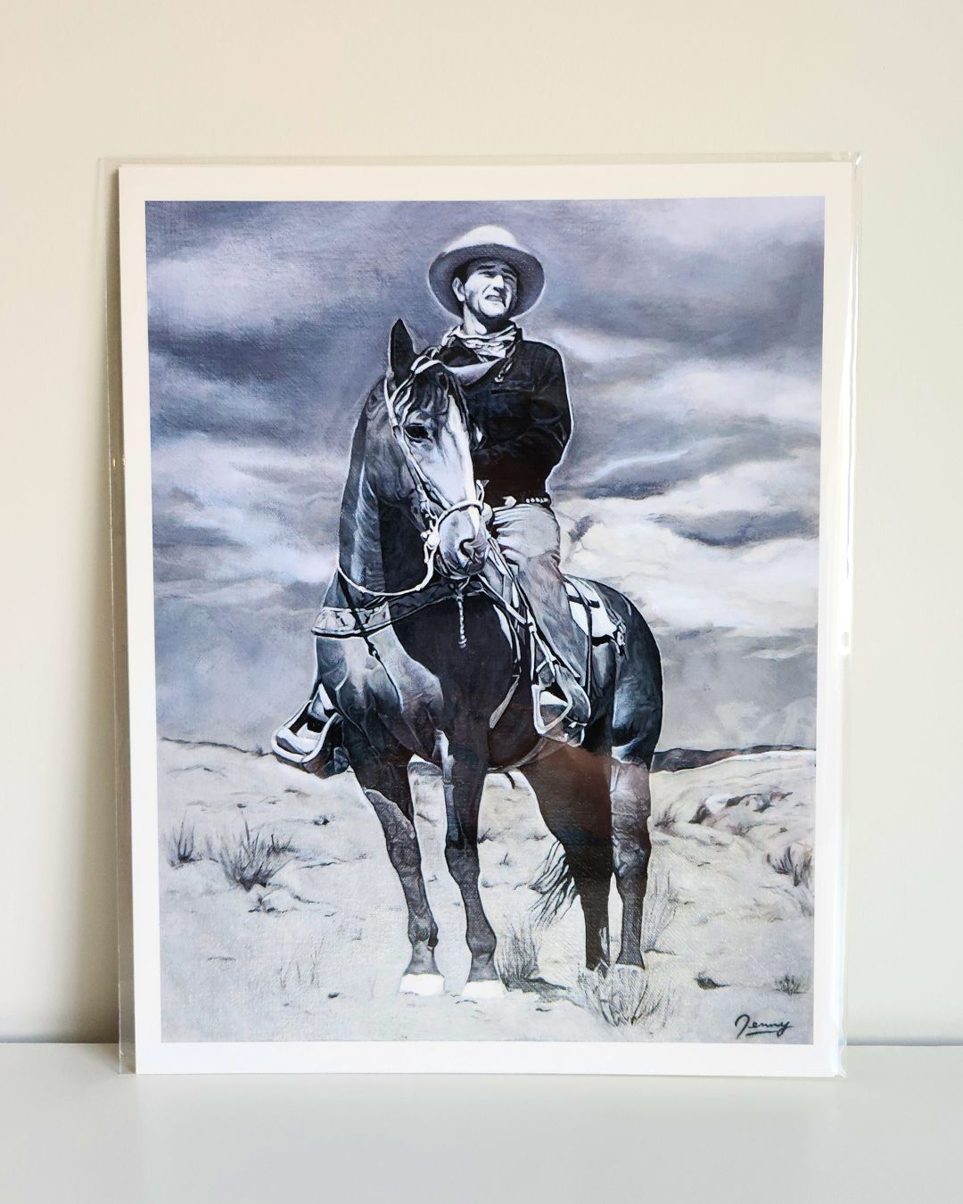Western cowboy portrait print by Full Art Alchemist, sleeved and standing upright against white wall